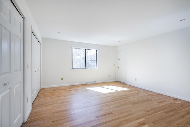 unfurnished bedroom with visible vents, light wood-type flooring, and baseboards