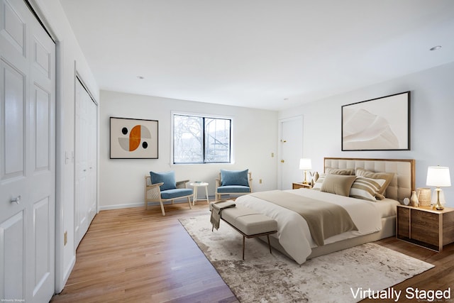 bedroom with baseboards and light wood-style floors