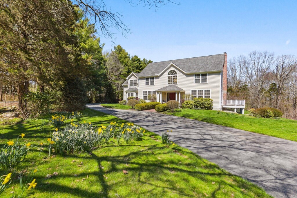 19 Juniper Ln, Stonington, CT 06378 - colonial house with a front lawn, a chimney, and aphalt driveway