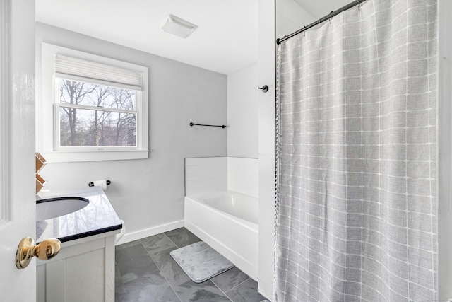 bathroom with visible vents, baseboards, a tub to relax in, marble finish floor, and vanity