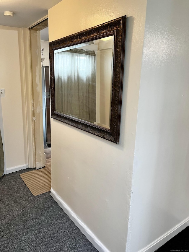 corridor featuring carpet and baseboards