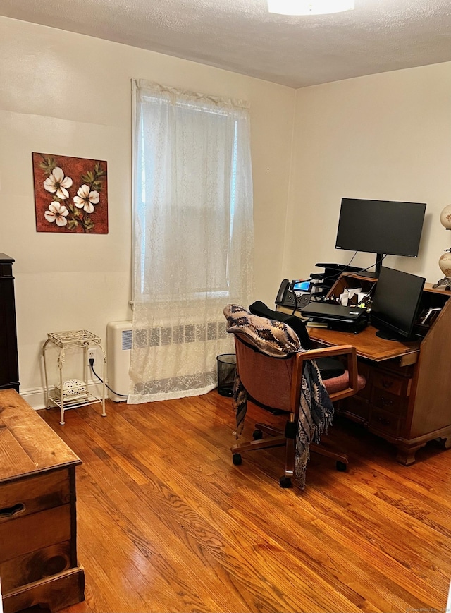 office area featuring a textured ceiling and wood finished floors