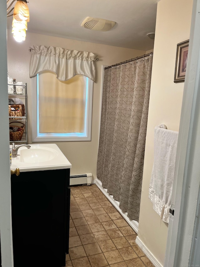 full bath with visible vents, curtained shower, baseboards, baseboard heating, and vanity