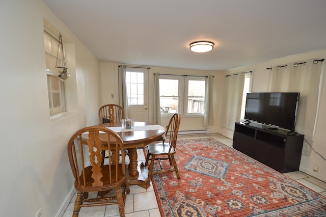 dining room featuring light tile patterned floors and baseboards