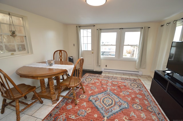 dining space with light tile patterned flooring and a baseboard radiator