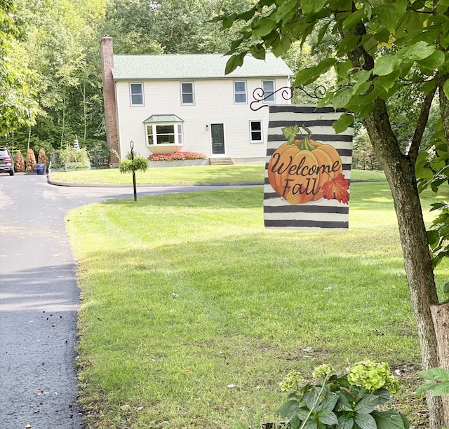 community sign featuring a lawn