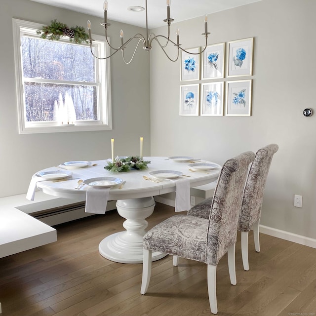 dining space featuring baseboards and wood-type flooring