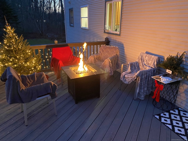 wooden terrace featuring a fire pit