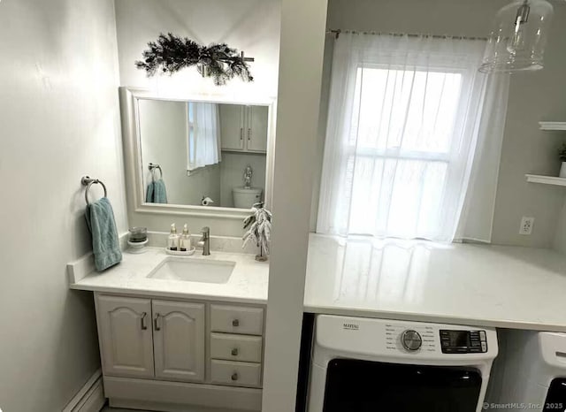 bathroom with washer / clothes dryer and vanity