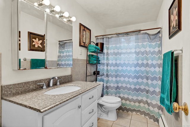 full bath with vanity, tile patterned flooring, wainscoting, tile walls, and toilet