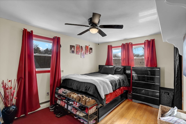 bedroom with wood finished floors and a ceiling fan