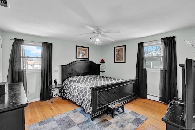 bedroom featuring multiple windows, light wood-style floors, and visible vents