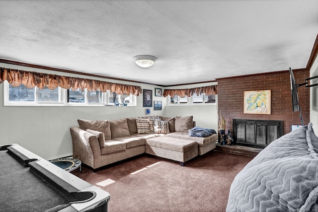 living area with a healthy amount of sunlight, a fireplace, a textured ceiling, and dark carpet