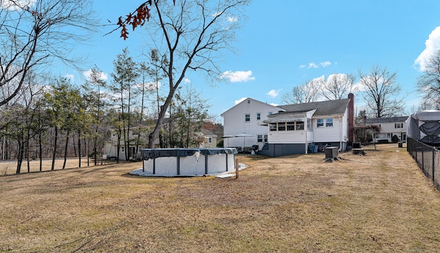 view of yard featuring a covered pool and fence