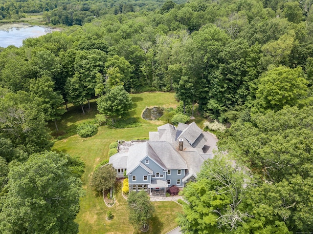 drone / aerial view with a water view and a view of trees