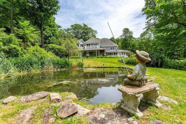 view of home's community with a yard and a water view