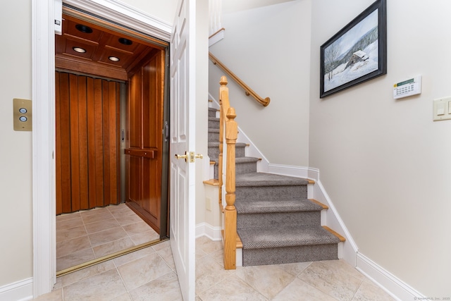 stairs with elevator, tile patterned flooring, recessed lighting, and baseboards