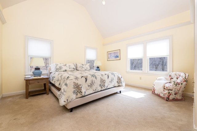 bedroom featuring baseboards, light carpet, and high vaulted ceiling