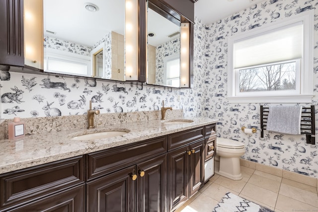 bathroom featuring wallpapered walls and a sink