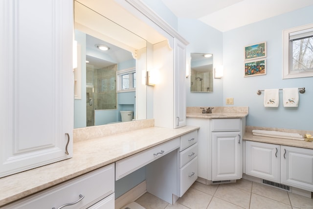 bathroom featuring vanity, a shower stall, visible vents, and tile patterned floors