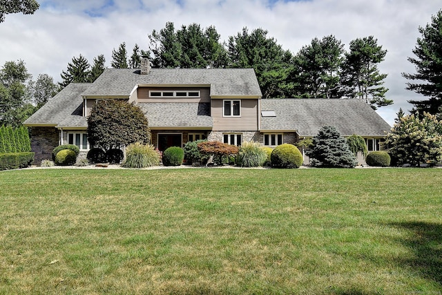 view of front of house with a chimney and a front yard