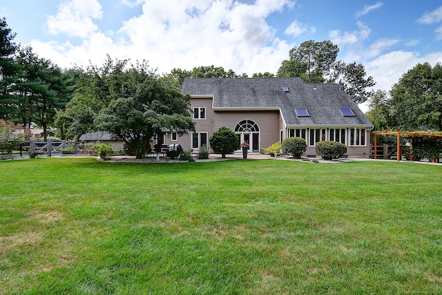 rear view of house featuring a yard and a patio