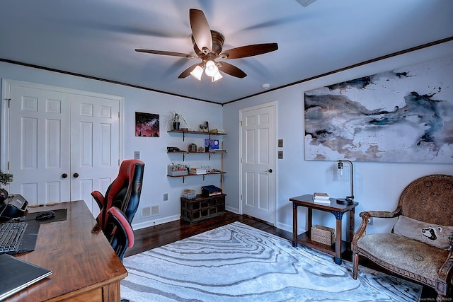 office space with visible vents, crown molding, baseboards, wood finished floors, and a ceiling fan