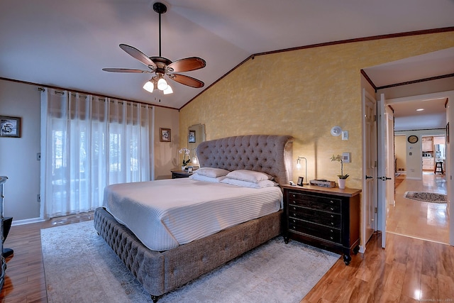 bedroom with lofted ceiling, a ceiling fan, wood finished floors, and crown molding