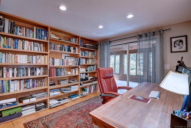 office with recessed lighting, a textured ceiling, and wood finished floors