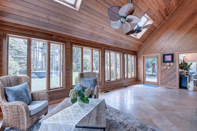 unfurnished sunroom with visible vents, plenty of natural light, wood ceiling, and vaulted ceiling with skylight