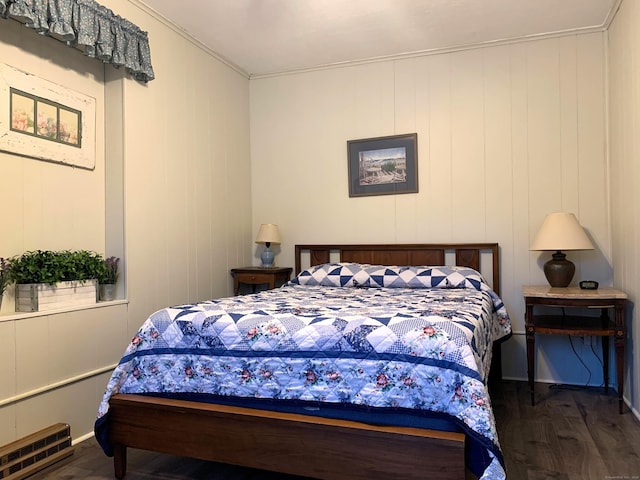 bedroom featuring visible vents, wood finished floors, and crown molding