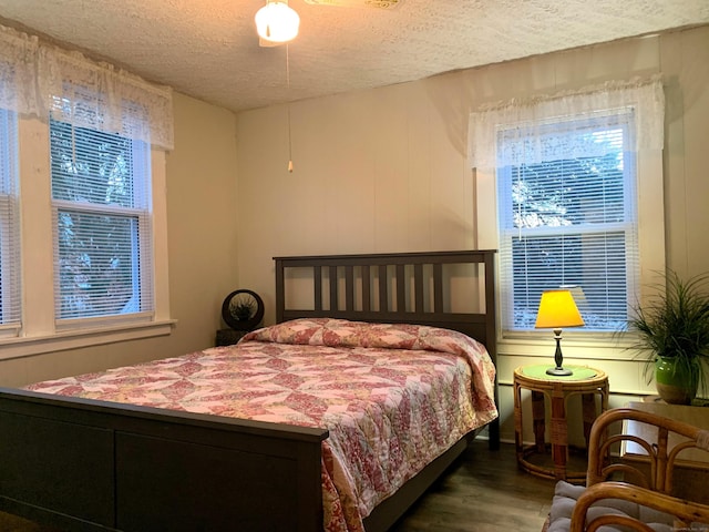 bedroom featuring a textured ceiling and wood finished floors