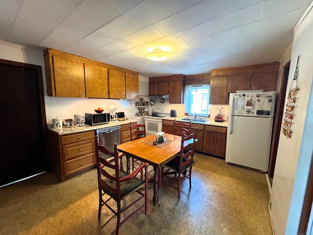 kitchen with a sink, light countertops, brown cabinets, and stainless steel appliances