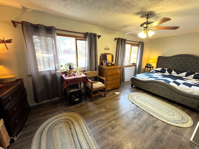 bedroom with a textured ceiling, ceiling fan, and wood finished floors