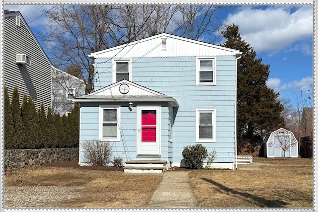 view of front of property with a storage shed and an outdoor structure