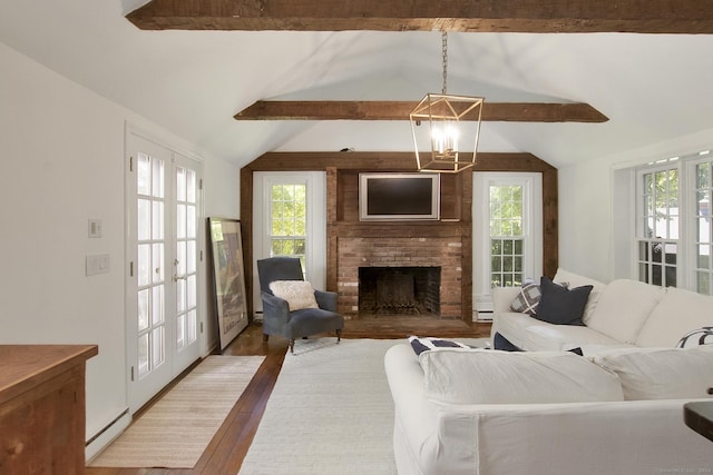 living area featuring an inviting chandelier, vaulted ceiling with beams, wood finished floors, and a wealth of natural light