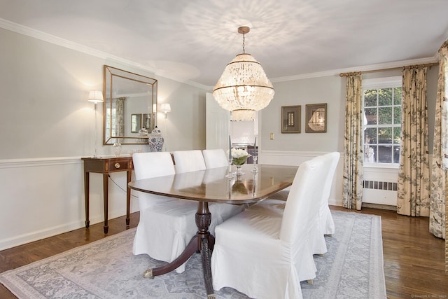 dining space with a notable chandelier, radiator heating unit, crown molding, and wood finished floors