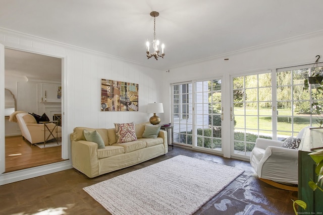 living area with a notable chandelier and ornamental molding