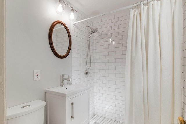 full bathroom with vanity, toilet, and a tile shower