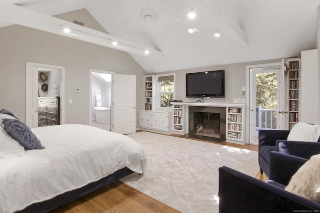 bedroom featuring lofted ceiling with beams, access to outside, multiple windows, and wood finished floors