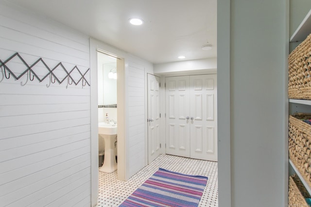 bathroom with recessed lighting and wooden walls