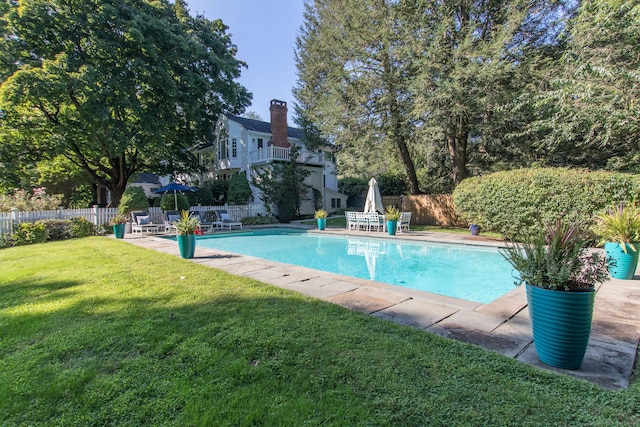 view of swimming pool with a patio area, a yard, a fenced backyard, and a fenced in pool