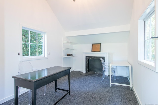 home office featuring a high end fireplace, baseboards, lofted ceiling, and dark colored carpet