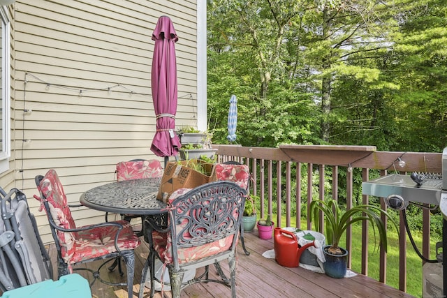 wooden terrace with outdoor dining space