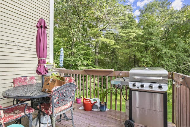 wooden terrace featuring a grill