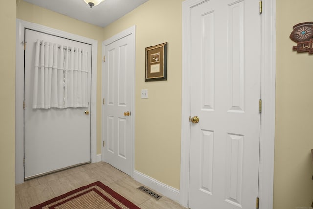 entryway with baseboards and visible vents