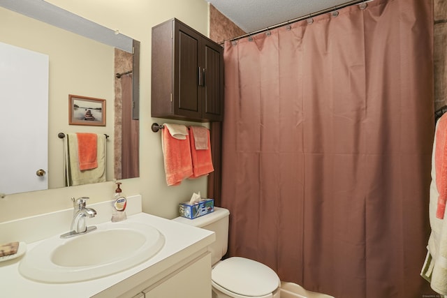 full bathroom with vanity, toilet, a shower with curtain, and a textured ceiling