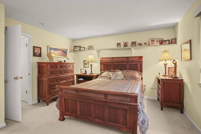 bedroom featuring light colored carpet and baseboards