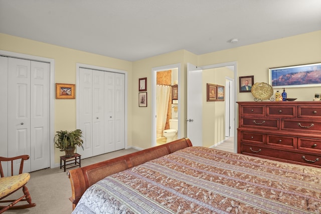 carpeted bedroom with baseboards and multiple closets