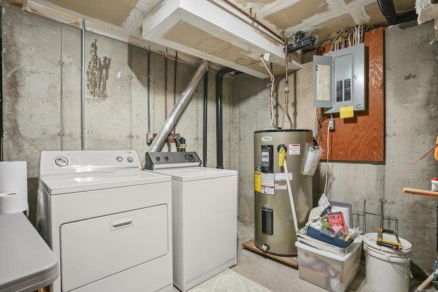 clothes washing area featuring electric panel, laundry area, washing machine and dryer, and electric water heater